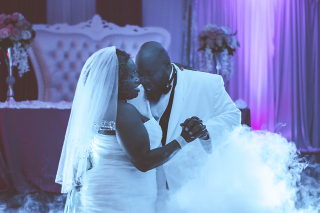 A wedding couple sharing a kiss on the dance floor