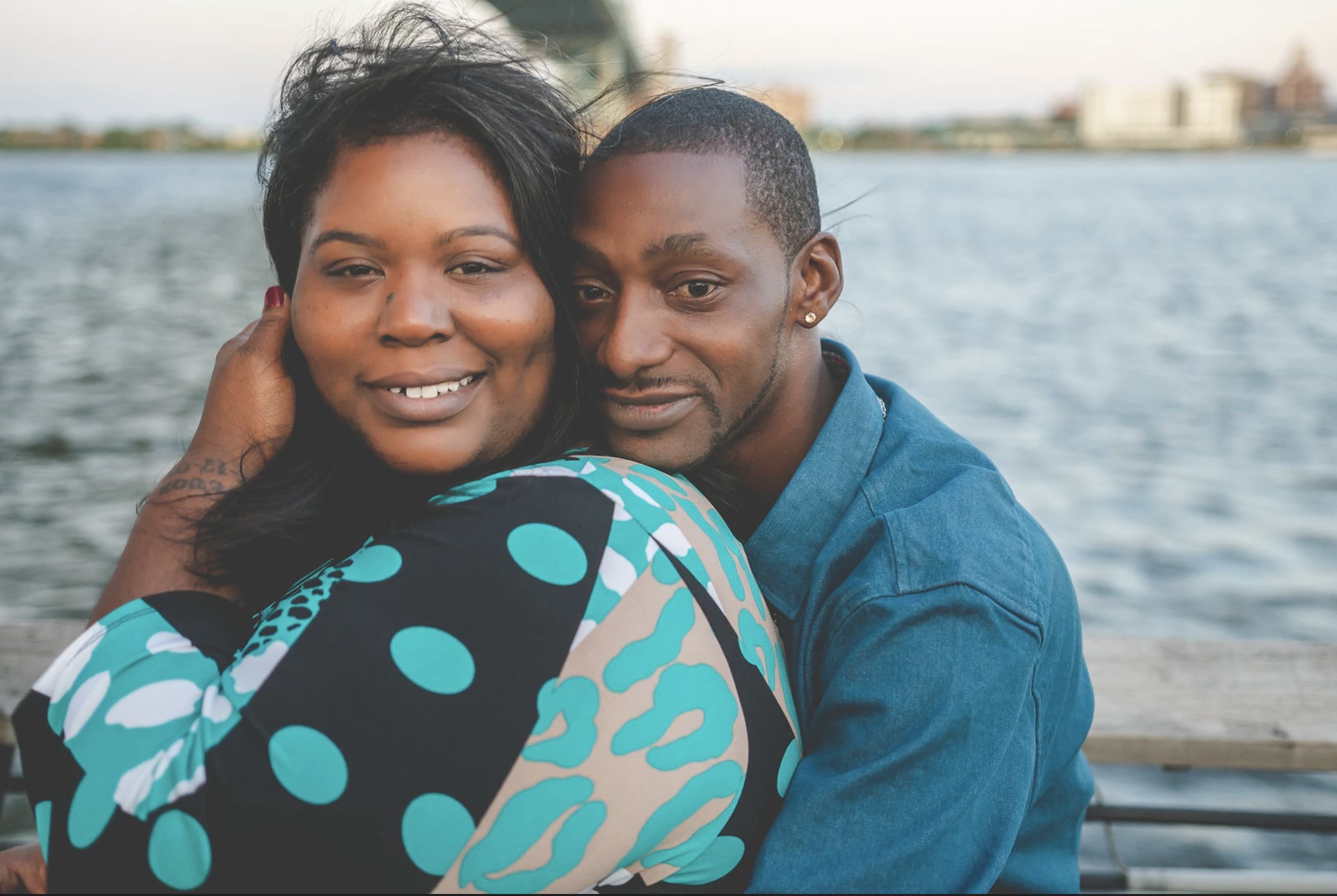 A couple embracing beside the waterfront
