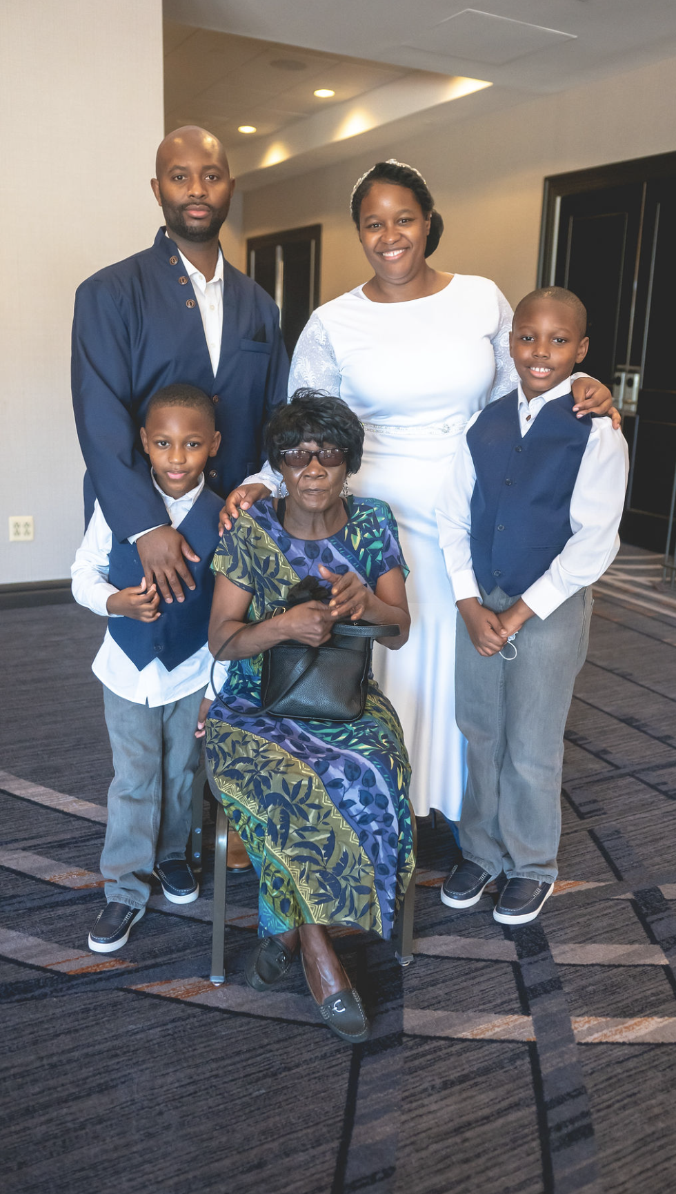 A family gathered around a seated elder at a celebration