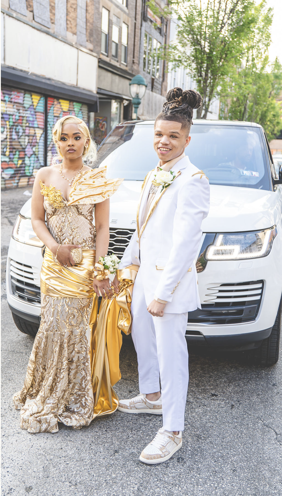 Two people celebrating in gold and white formalwear