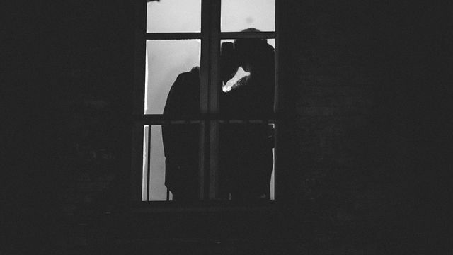 A quiet moment together beside a window